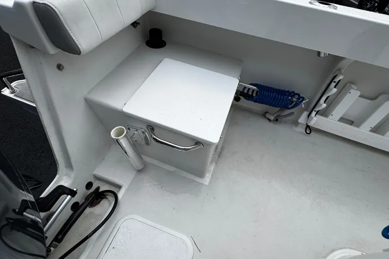 Slide: The Image of 2021 Parker 2100 Center Console boat interior with storage and fishing rod holder. - 35