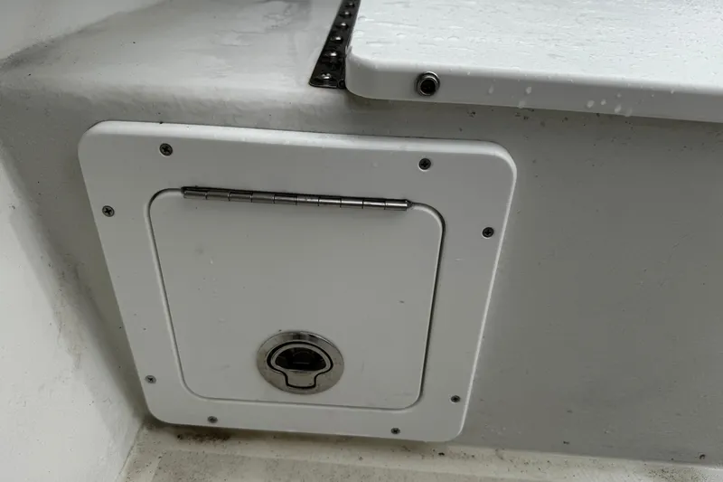 Slide: The Image of Hinged compartment on 2021 Parker 2100 Center Console boat, featuring a secure latch. - 36