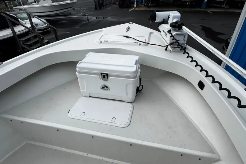 Slide: The Image of 2021 Parker 2100 Center Console boat deck with cooler and trolling motor. - 42