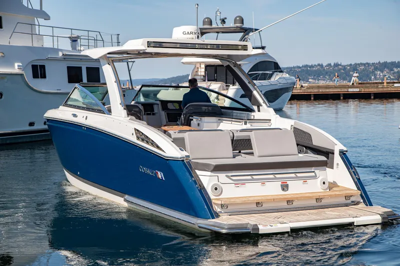 Slide: The Image of 2023 Cobalt R33 boat cruising on a calm lake, showcasing sleek design and luxury features. - 10