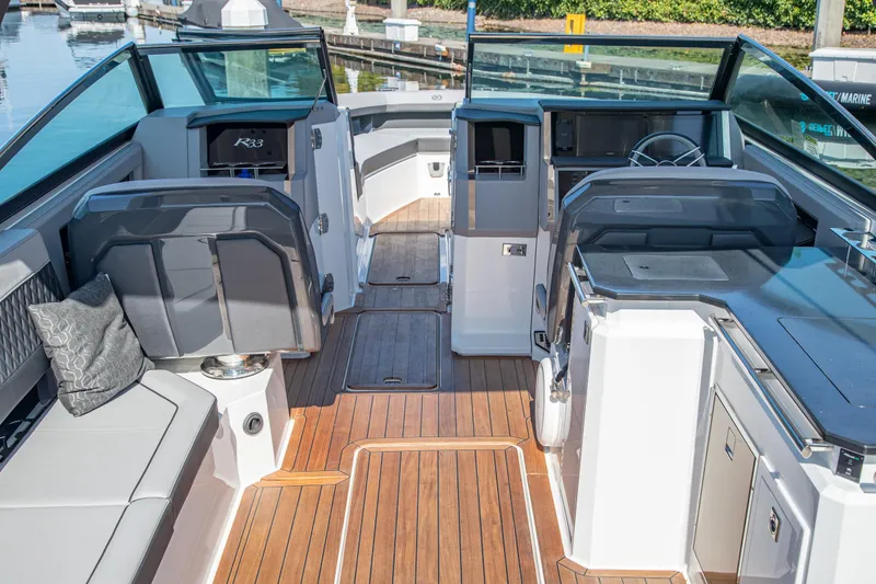 Slide: The Image of Luxurious 2023 Cobalt R33 boat interior with sleek seating and modern dashboard. - 17