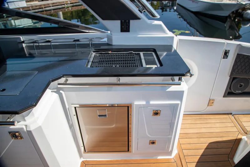 Slide: The Image of Outdoor kitchen on 2023 Cobalt R33 boat with grill and storage. - 20
