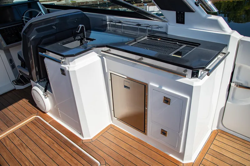 Slide: The Image of Luxury outdoor kitchen on 2023 Cobalt R33 boat with grill and storage. - 21