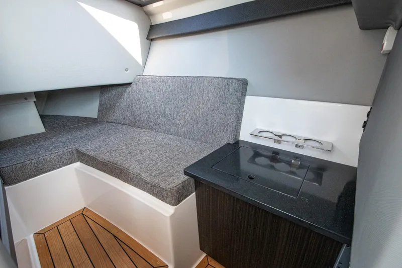 Slide: The Image of 2023 Cobalt R33 interior cabin with gray seating and wooden flooring. - 39