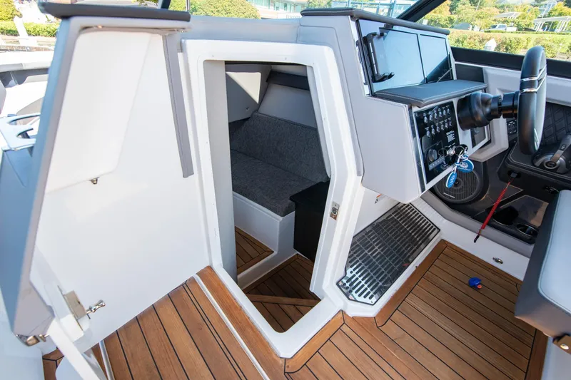 Slide: The Image of 2023 Cobalt R33 boat interior with modern helm and cozy cabin space. - 41