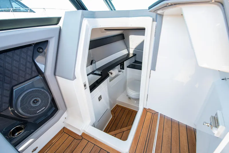 Slide: The Image of 2023 Cobalt R33 boat interior with modern bathroom and wooden flooring. - 43