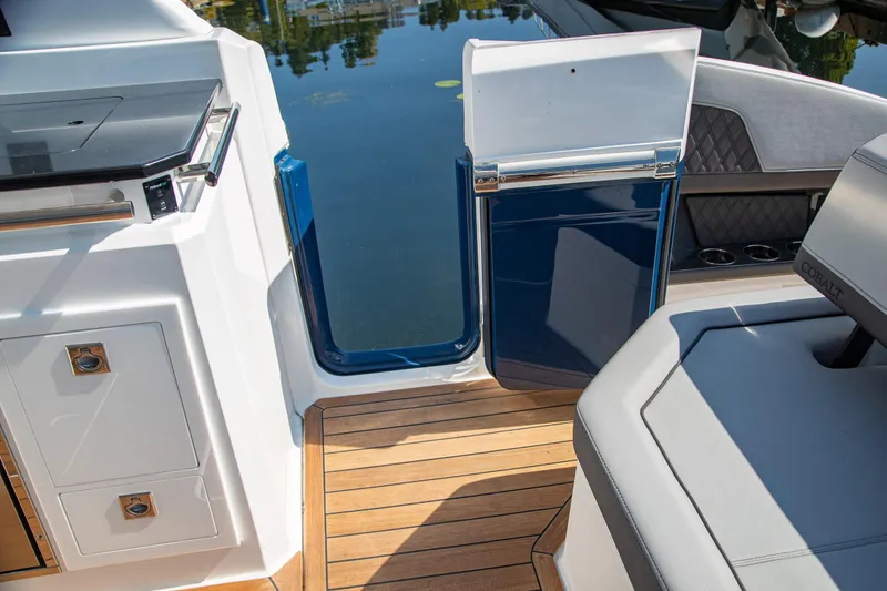 Slide: The Image of 2023 Cobalt R33 boat interior with teak flooring and sleek design elements. - 46