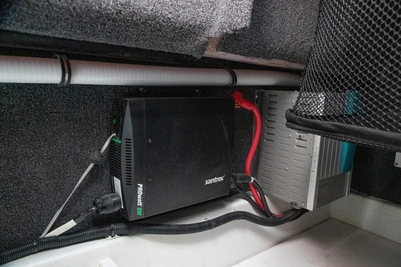 Slide: The Image of Electrical components in a 2023 Cobalt R33 boat, featuring a Xantrex ProWatt SW inverter. - 56