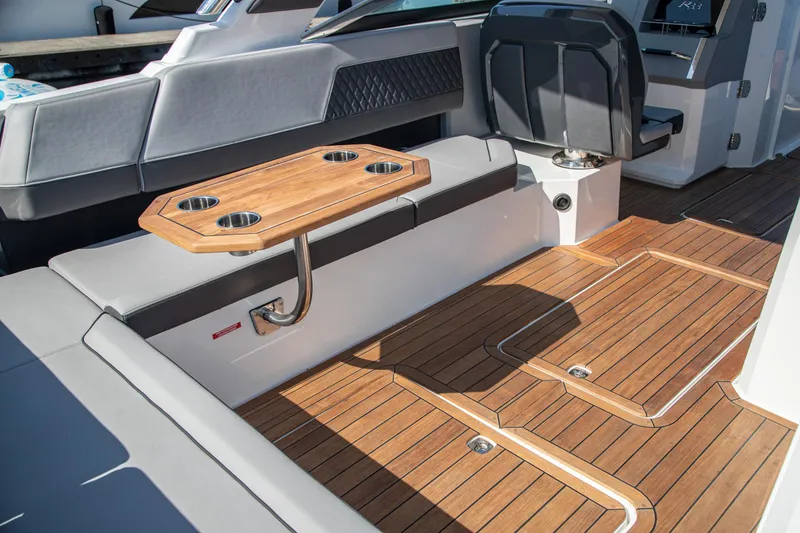 Slide: The Image of 2023 Cobalt R33 boat interior with wooden flooring and seating area. - 58