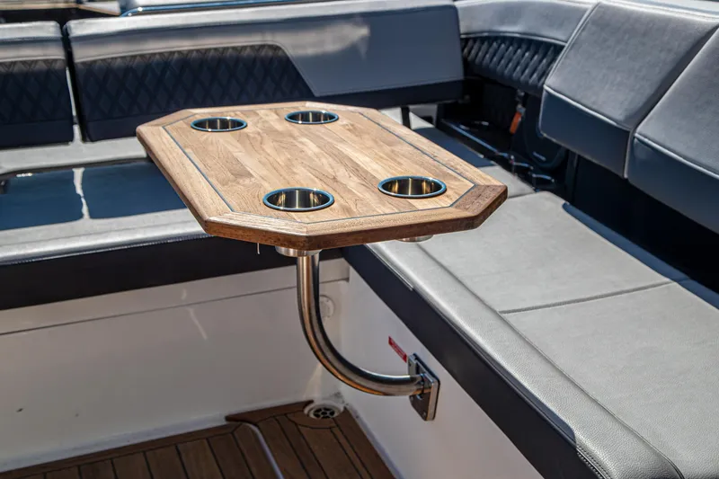 Slide: The Image of Luxury seating area with wooden table on 2023 Cobalt R33 boat. - 59