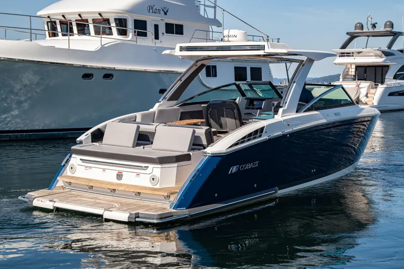 Slide: The Image of 2023 Cobalt R33 luxury boat docked in marina, featuring sleek design and spacious seating. - 7