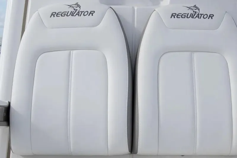 Slide: The Image of 2026 Regulator 28 Forward Seating boat with white cushioned seats. - 2