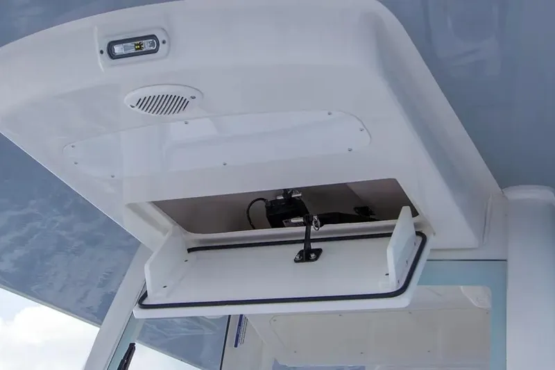 Slide: The Image of 2026 Regulator 28 Forward Seating boat storage compartment with open hatch and interior view. - 4
