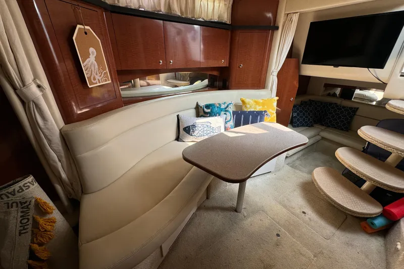 Slide: The Image of Interior of 2003 Sea Ray 320 Sundancer with cozy seating and modern decor. - 11