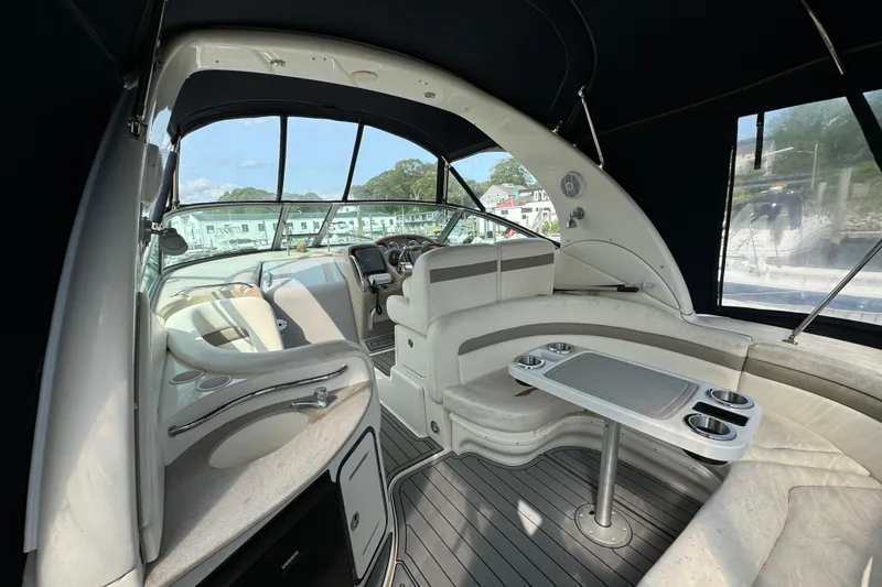 Slide: The Image of Interior of 2003 Sea Ray 320 Sundancer yacht with seating and helm. - 4