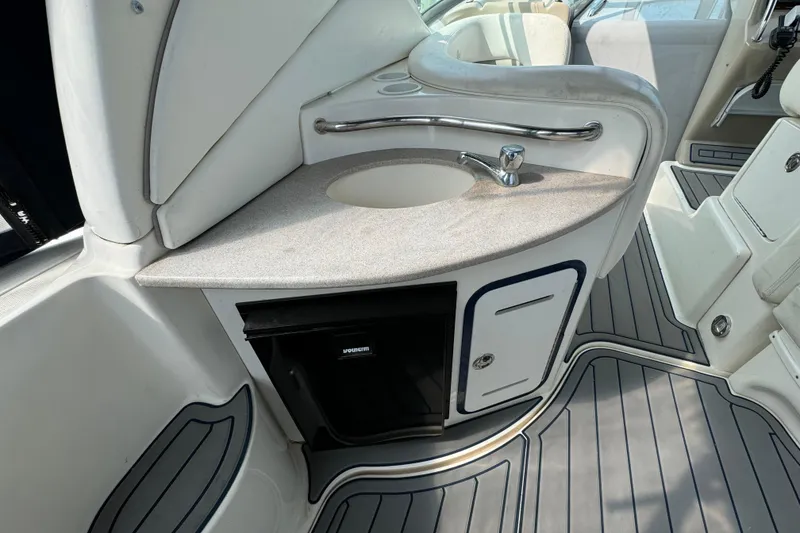 Slide: The Image of 2003 Sea Ray 320 Sundancer boat interior with sink and storage area. - 5