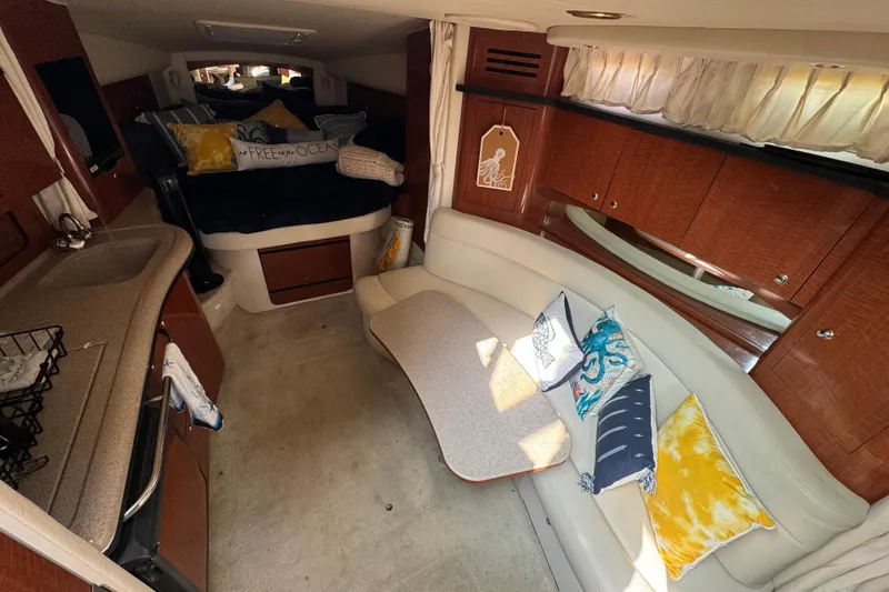 Slide: The Image of Interior of 2003 Sea Ray 320 Sundancer with cozy seating and stylish decor. - 8