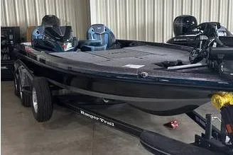 Slide: The Image of 2025 Ranger Z520R boat in a garage, featuring dual motors and a sleek black design. - 3