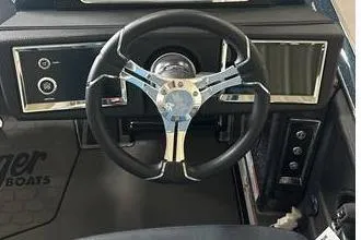 Slide: The Image of 2025 Ranger Z520R boat dashboard with steering wheel and control panel. - 5