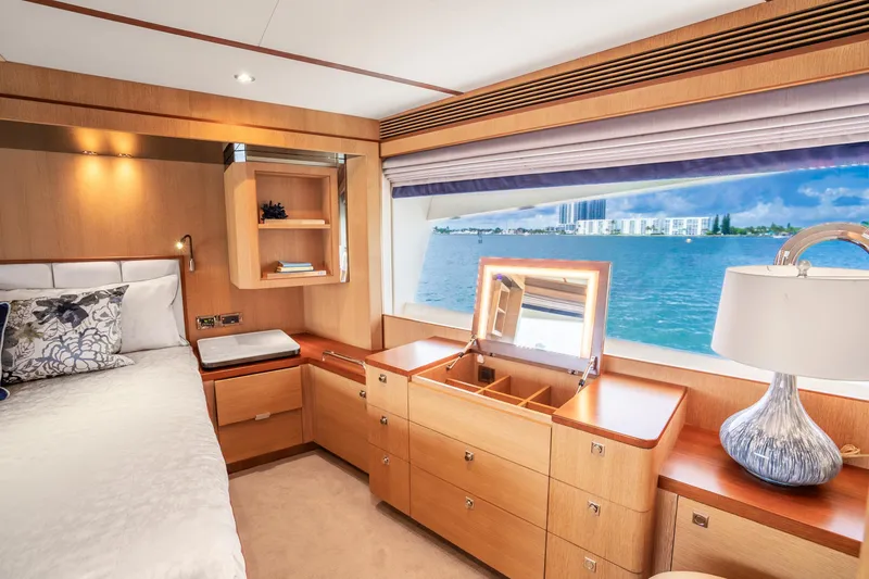 Slide: The Image of Luxurious Horizon FD80 yacht bedroom with ocean view, elegant wood furnishings, and modern decor. - 100