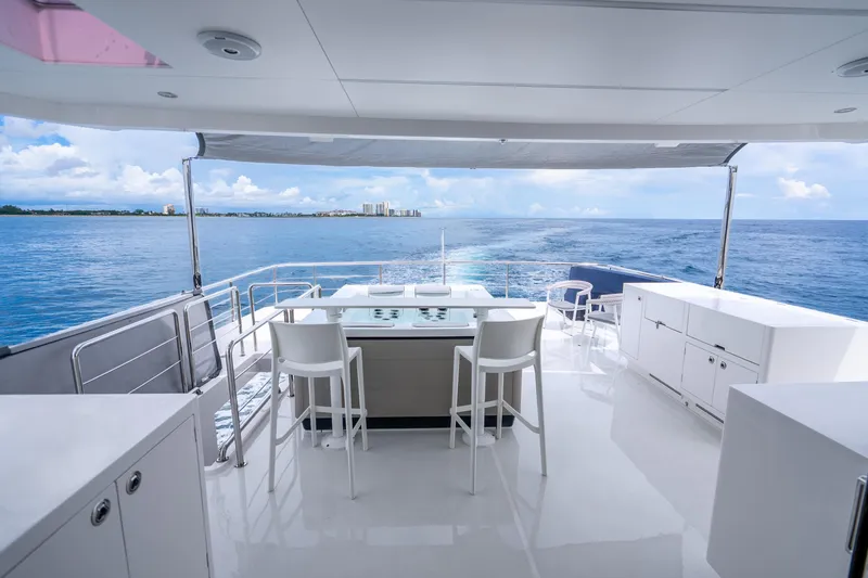 Slide: The Image of Luxurious Horizon FD80 yacht deck with ocean view, featuring modern seating and sleek design, 2020 model. - 111