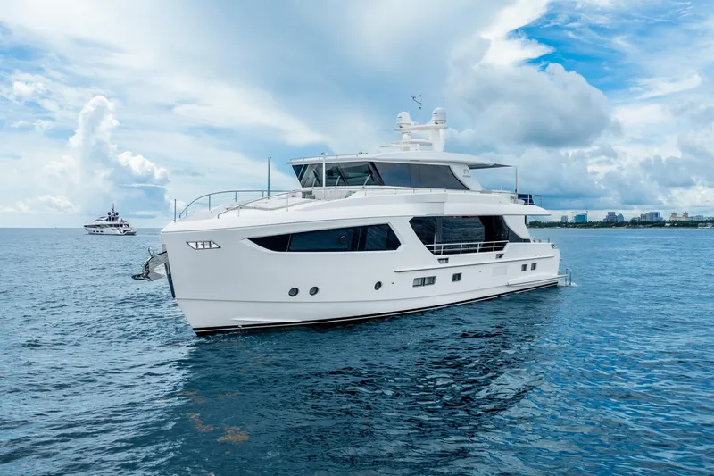 Slide: The Image of Luxurious 2020 Horizon FD80 yacht cruising on a serene ocean under a partly cloudy sky. - 15