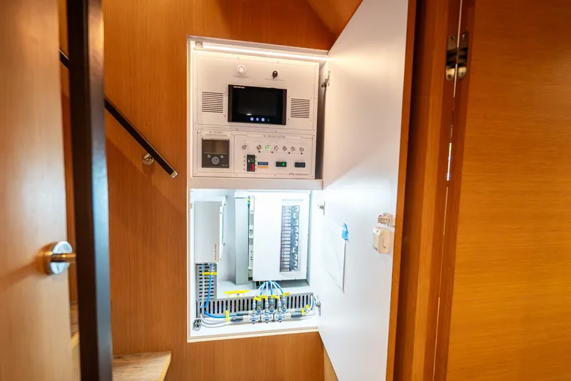 Slide: The Image of Electrical control panel inside Horizon FD80 yacht, 2020 model, with wooden interior. - 19