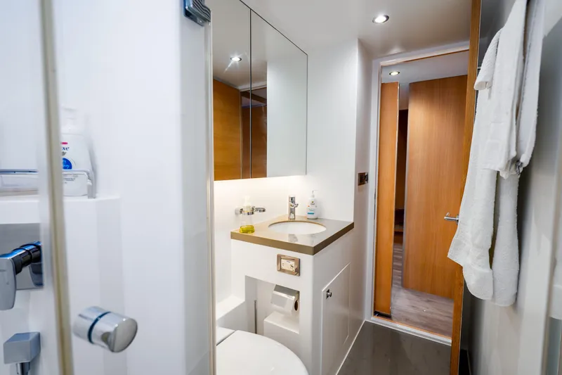 Slide: The Image of Modern bathroom interior on 2020 Horizon FD80 yacht, featuring sleek fixtures and wooden accents. - 21