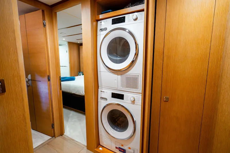 Slide: The Image of Stacked washer and dryer in wooden cabin hallway, Horizon FD80 yacht, 2020 model. - 22