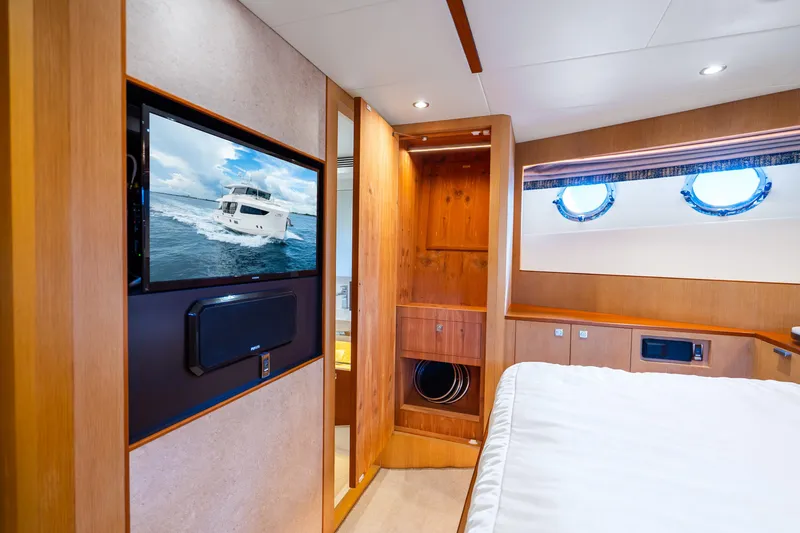 Slide: The Image of Luxurious Horizon FD80 yacht interior with wood paneling, TV, and porthole windows, 2020 model. - 23