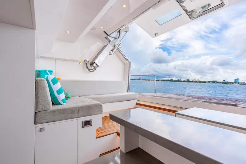 Slide: The Image of Luxurious Horizon FD80 yacht interior with ocean view, featuring modern seating and vibrant cushions. - 32