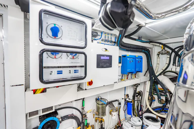 Slide: The Image of Engine room of 2020 Horizon FD80 yacht with control panels and wiring. - 39