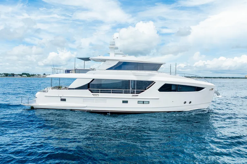 Slide: The Image of Luxury 2020 Horizon FD80 yacht cruising on open sea under blue sky. - 5