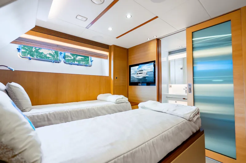 Slide: The Image of Luxurious Horizon FD80 yacht bedroom with twin beds, TV, and modern decor, 2020 model. - 52