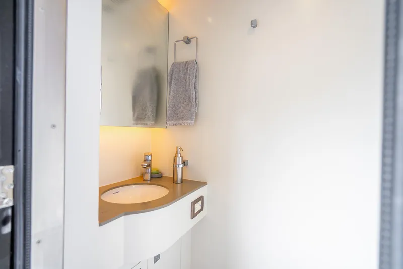 Slide: The Image of Modern bathroom interior in 2020 Horizon FD80 yacht, featuring sleek sink and mirror. - 54