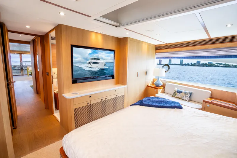 Slide: The Image of Luxurious Horizon FD80 yacht bedroom with waterfront view, modern decor, and large TV, 2020 model. - 57