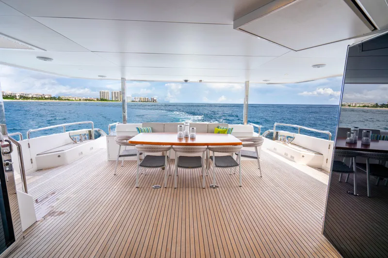 Slide: The Image of Luxurious Horizon FD80 yacht deck with ocean view, featuring elegant dining area, 2020 model. - 63