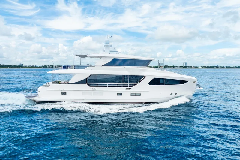 Slide: The Image of Luxurious 2020 Horizon FD80 yacht cruising on open blue sea under a cloudy sky. - 73