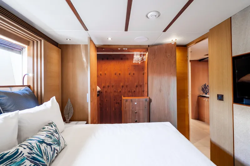 Slide: The Image of Luxurious bedroom interior on 2020 Horizon FD80 yacht, featuring elegant wood finishes and modern decor. - 92