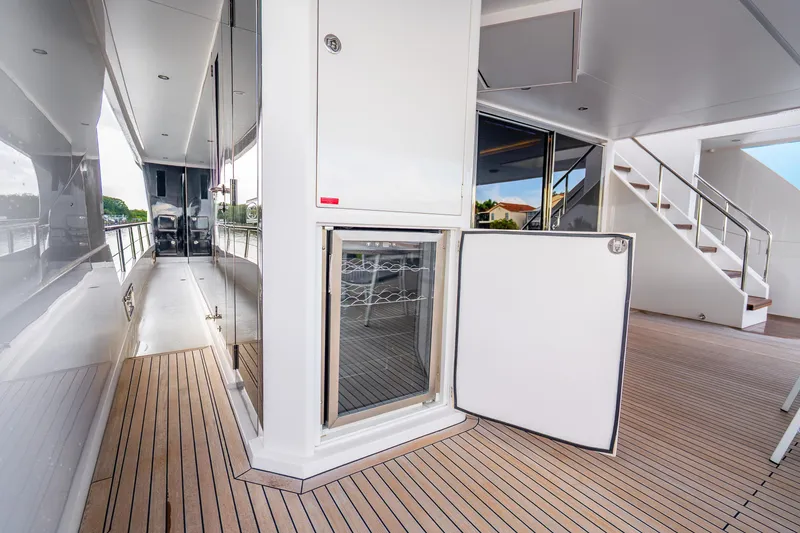 Slide: The Image of Luxurious Horizon FD80 yacht deck with open fridge, sleek design, and modern amenities, 2020 model. - 97