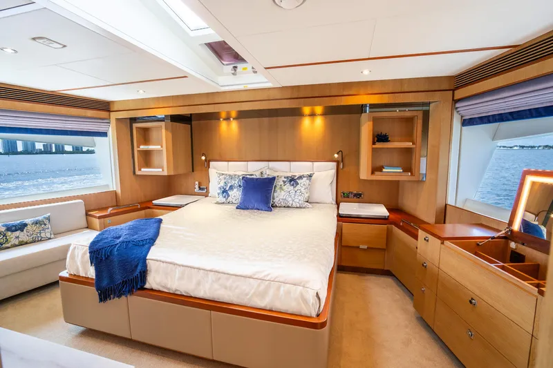 Slide: The Image of Luxurious 2020 Horizon FD80 yacht bedroom with elegant wood finishes and ocean view. - 99