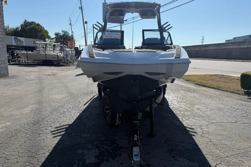 Slide: The Image of 2026 Supra SA 550 boat on trailer in outdoor dealership lot. - 1