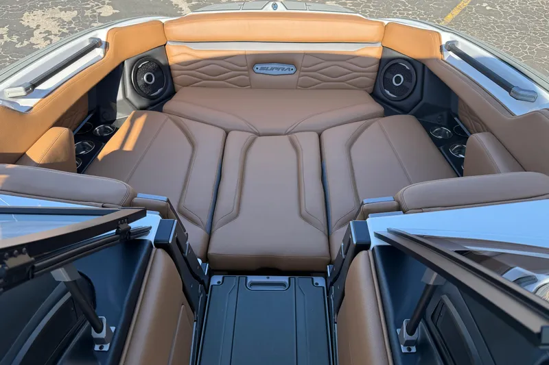 Slide: The Image of Luxurious interior of 2026 Supra SA 550 boat with tan leather seating and speakers. - 11