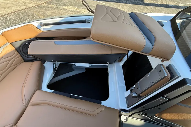 Slide: The Image of 2026 Supra SA 550 boat interior with tan leather seats and storage compartment. - 13