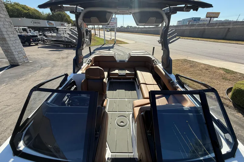 Slide: The Image of 2026 Supra SA 550 boat interior with brown seating and open deck design. - 18