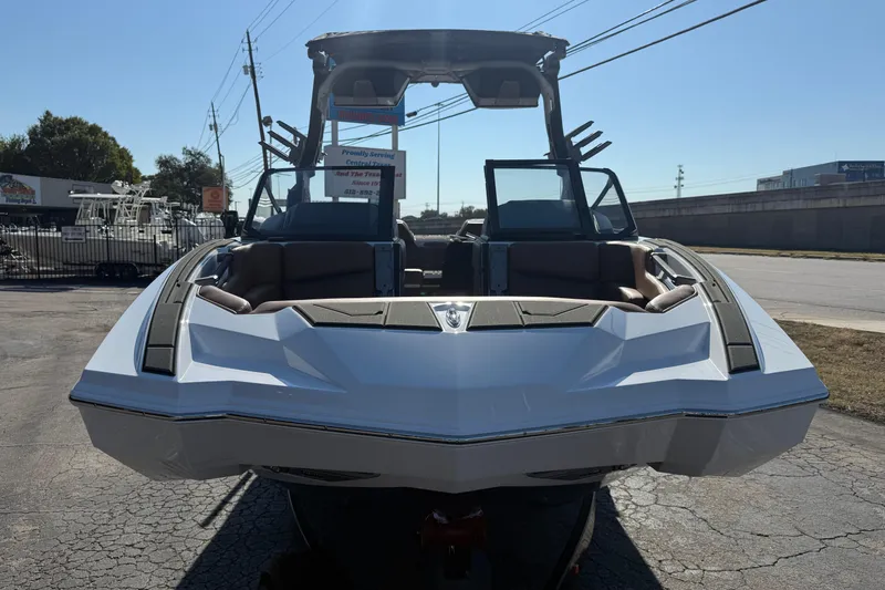 Slide: The Image of 2026 Supra SA 550 boat, sleek design, parked outdoors on a sunny day. - 2