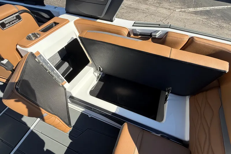 Slide: The Image of 2026 Supra SA 550 boat interior with open storage compartments and tan seating. - 21