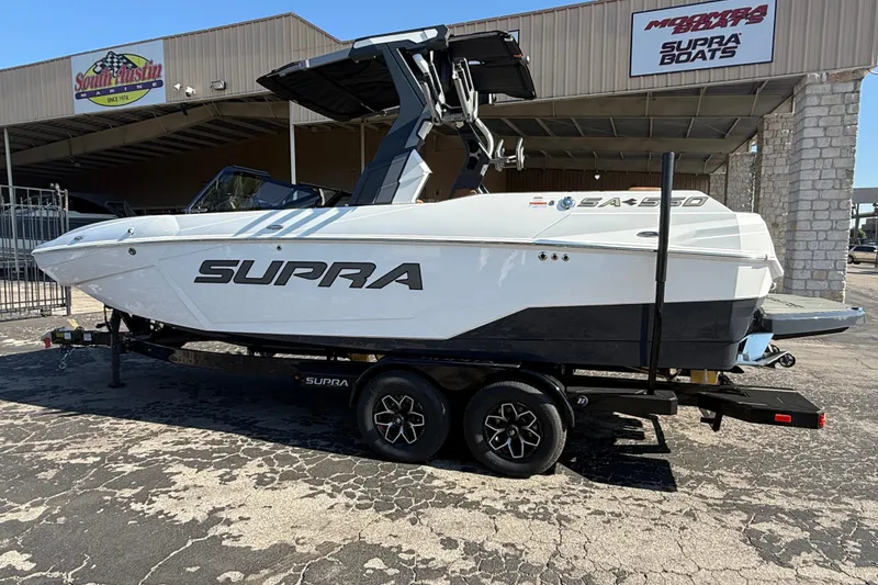 Slide: The Image of 2026 Supra SA 550 boat on trailer at dealership, showcasing sleek design and modern features. - 3