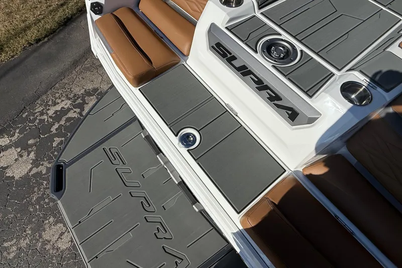 Slide: The Image of 2026 Supra SA 550 boat deck with brown seating and gray flooring. - 6
