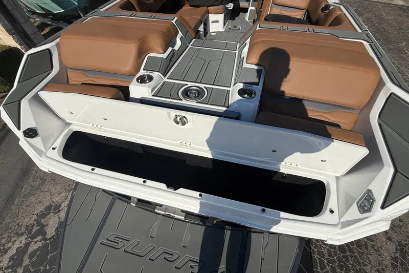 Slide: The Image of 2026 Supra SA 550 boat interior with brown seating and open storage compartment. - 7